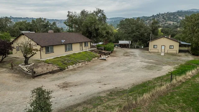 a view of a house with a yard and street