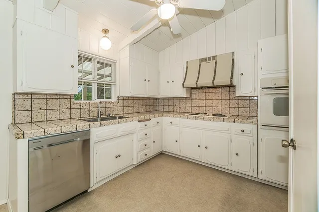 a spacious bathroom with a double vanity sink and a mirror