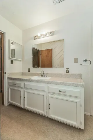 a view of a house with backyard and a tree