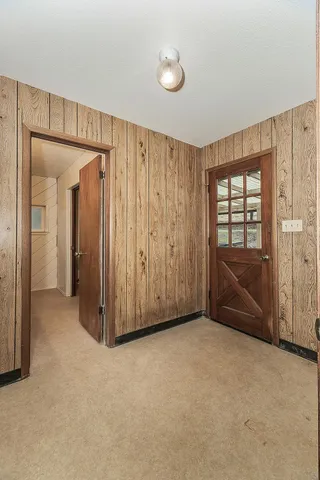 a view of a house with a backyard and trees