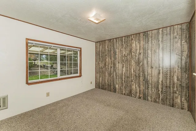 a view of an empty room with a fireplace