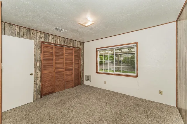 a view of a hallway with wooden walls and windows