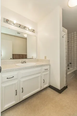 a view of house with backyard and trees