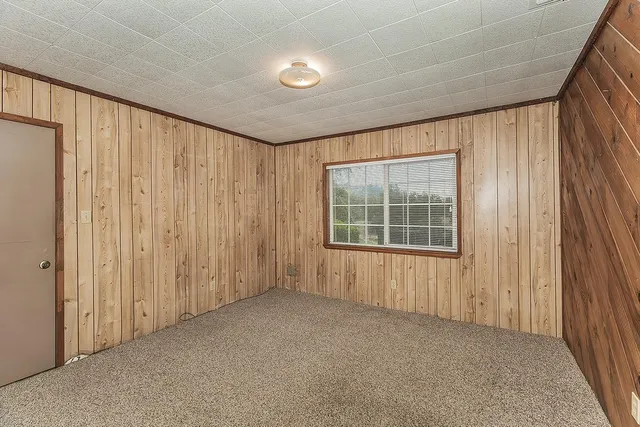 a view of a house with a yard and sitting area