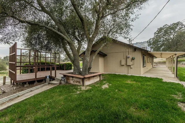 a view of empty room with wooden floor and fireplace
