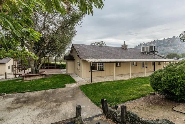 a view of empty room with wooden floor and fireplace