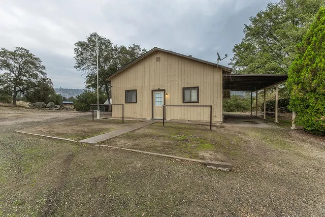 an empty room with a window and a ceiling fan
