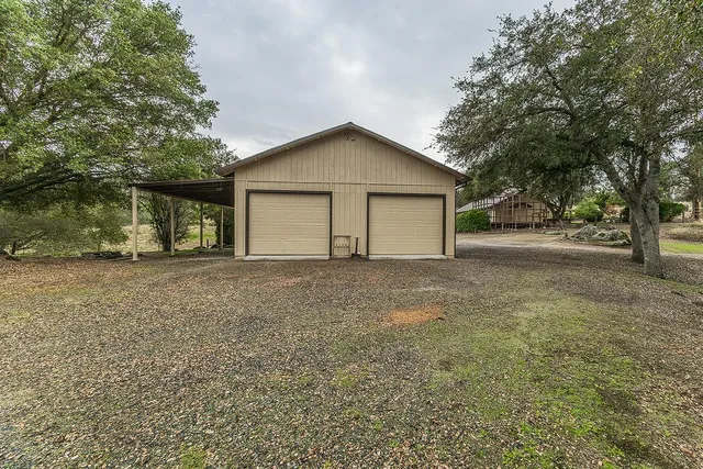 an aerial view of a house with a yard and hanging chair