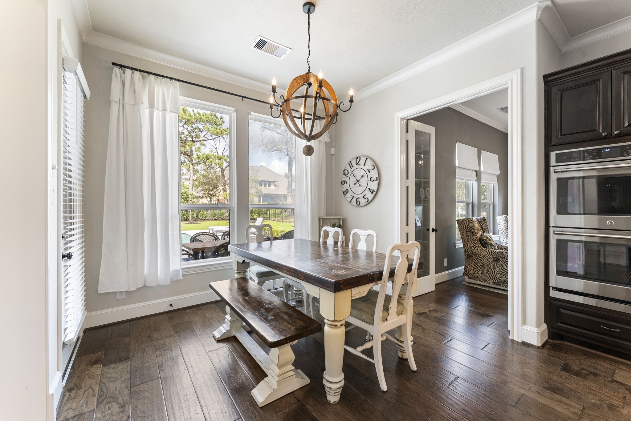 5519 Bright Timber Landing Drive Spring, TX 77386 - Photo 11 of 39 a dining room with furniture a chandelier and wooden floor