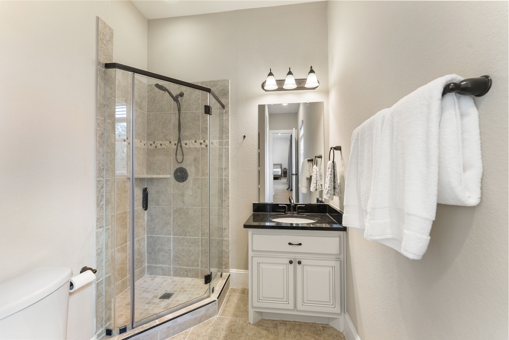 5519 Bright Timber Landing Drive Spring, TX 77386 - Photo 23 of 39 a bathroom with a shower a mirror and a sink