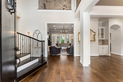 a large kitchen with stainless steel appliances granite countertop plenty wooden cabinets counter space and a chandelier