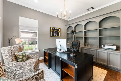 a dining room with furniture a chandelier and wooden floor