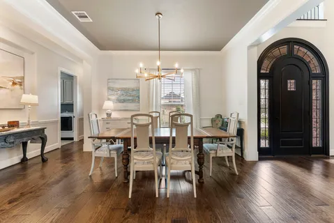 a living room with furniture chandelier and a fireplace