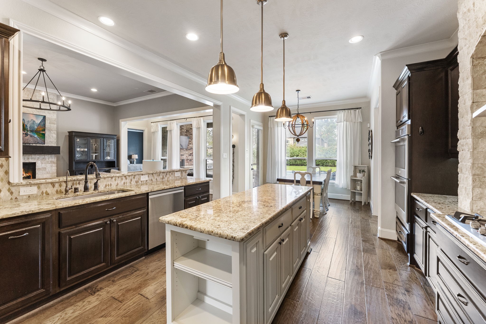 5519 Bright Timber Landing Drive Spring, TX 77386 - Photo 9 of 39 a large kitchen with stainless steel appliances granite countertop plenty wooden cabinets counter space and a chandelier