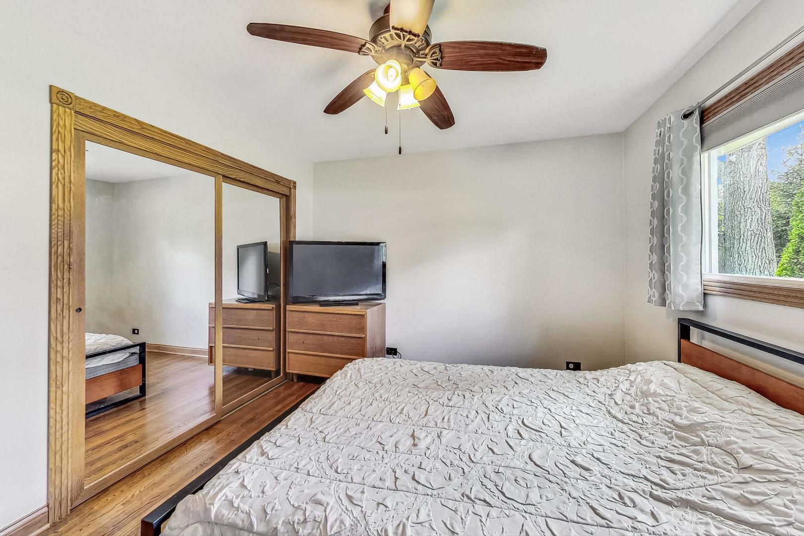 360 South St Marys Road Libertyville, IL 60048 - Photo 23 of 46 a bedroom with a bed and a chandelier