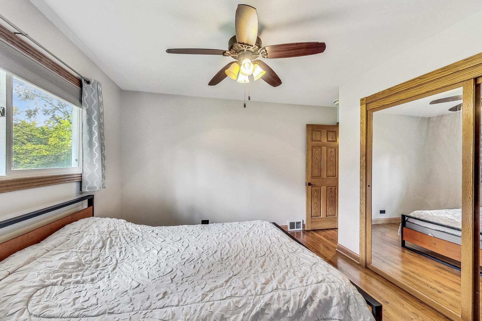360 South St Marys Road Libertyville, IL 60048 - Photo 24 of 46 a bedroom with a bed and a chandelier