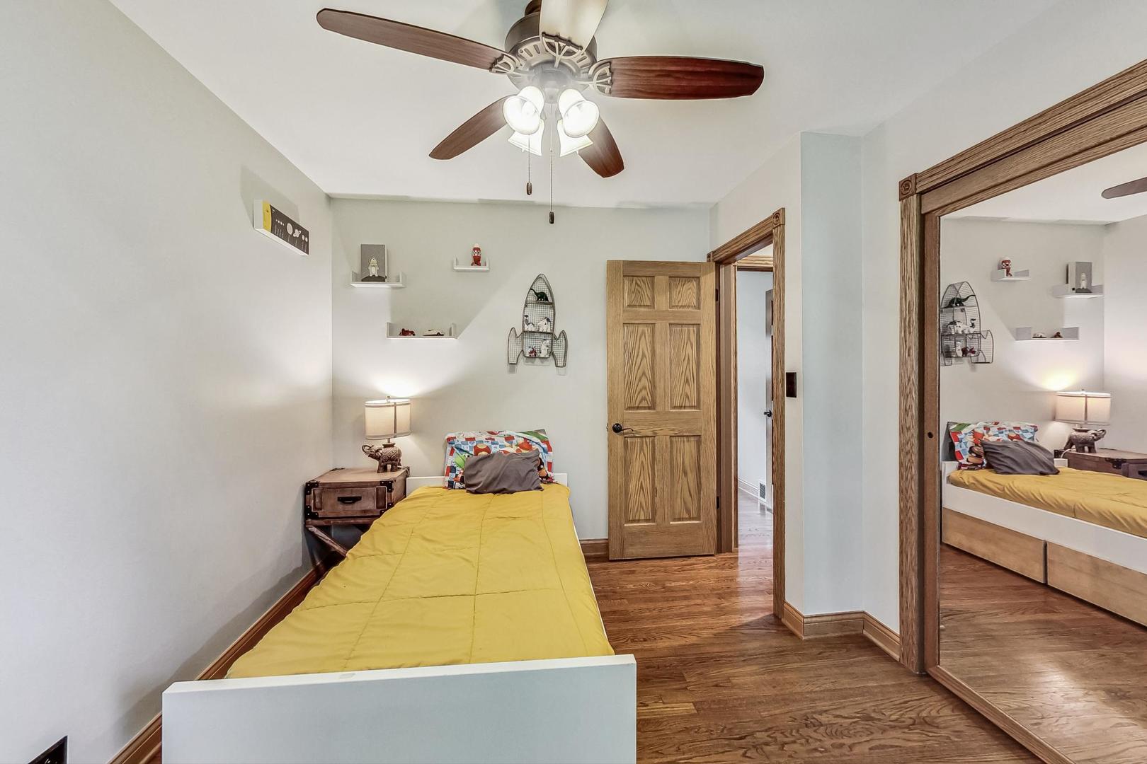 360 South St Marys Road Libertyville, IL 60048 - Photo 26 of 46 a room with closet and a chandelier fan