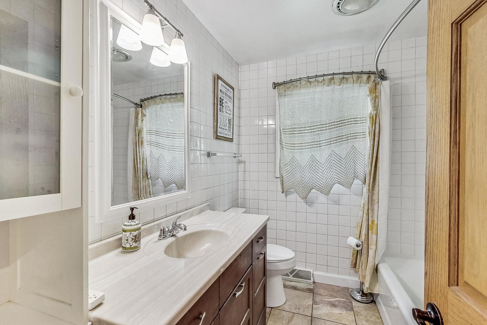 360 South St Marys Road Libertyville, IL 60048 - Photo 28 of 46 a bathroom with a sink vanity granite toilet and shower
