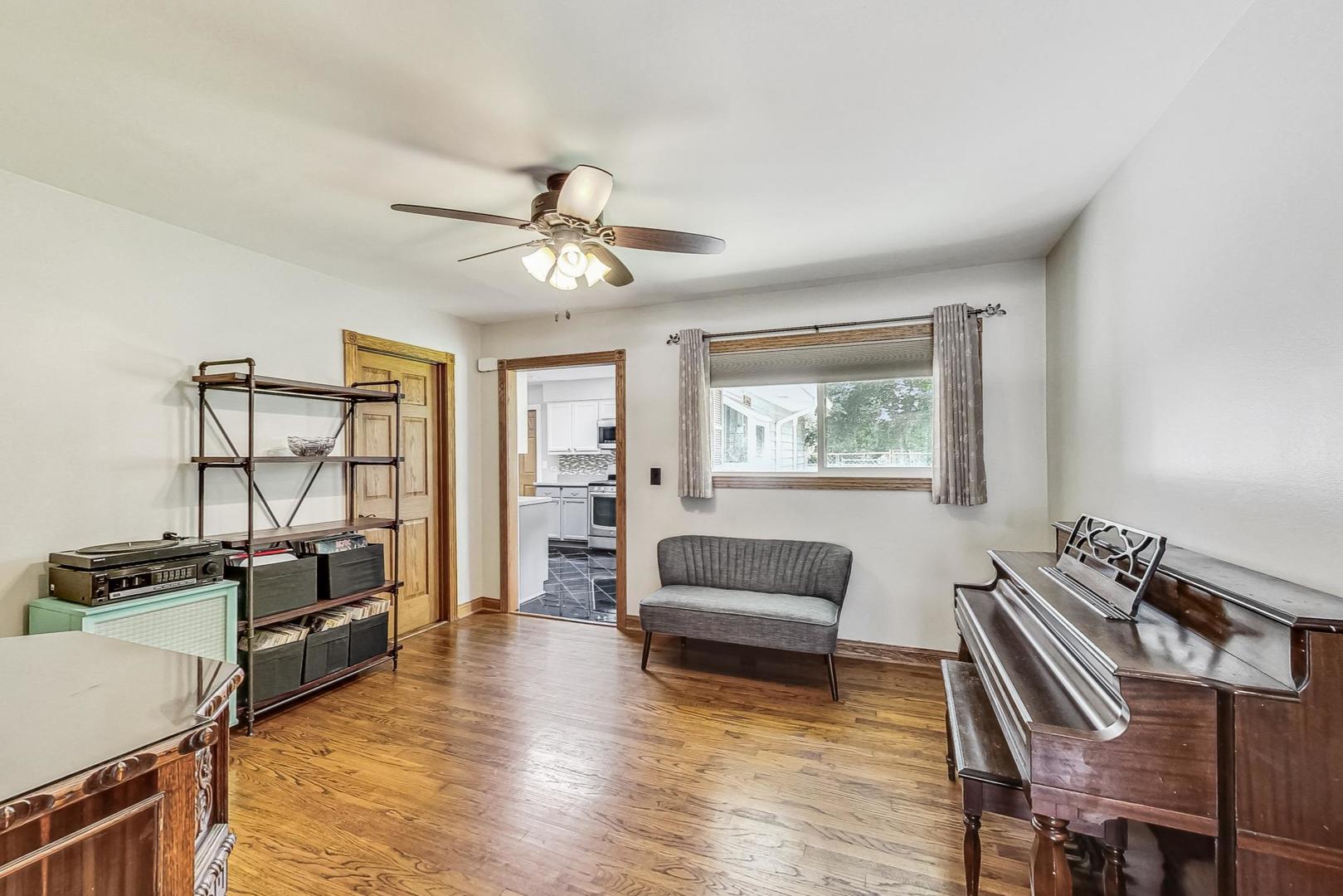360 South St Marys Road Libertyville, IL 60048 - Photo 8 of 46 a view of a livingroom with furniture a ceiling fan and wooden floor