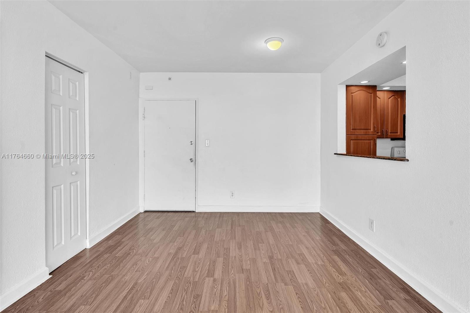5600 Collins Avenue, Unit 10J Miami Beach, FL 33140 - Photo 11 of 20 a view of a room with wooden floor and entryway