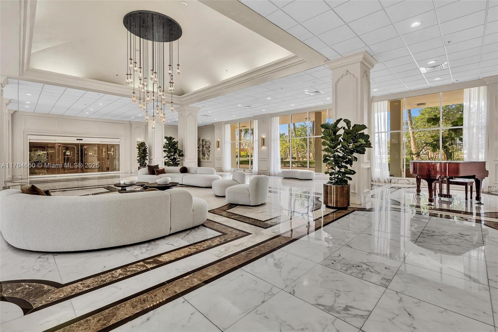 5600 Collins Avenue, Unit 10J Miami Beach, FL 33140 - Photo 15 of 20 a living room with furniture and a chandelier