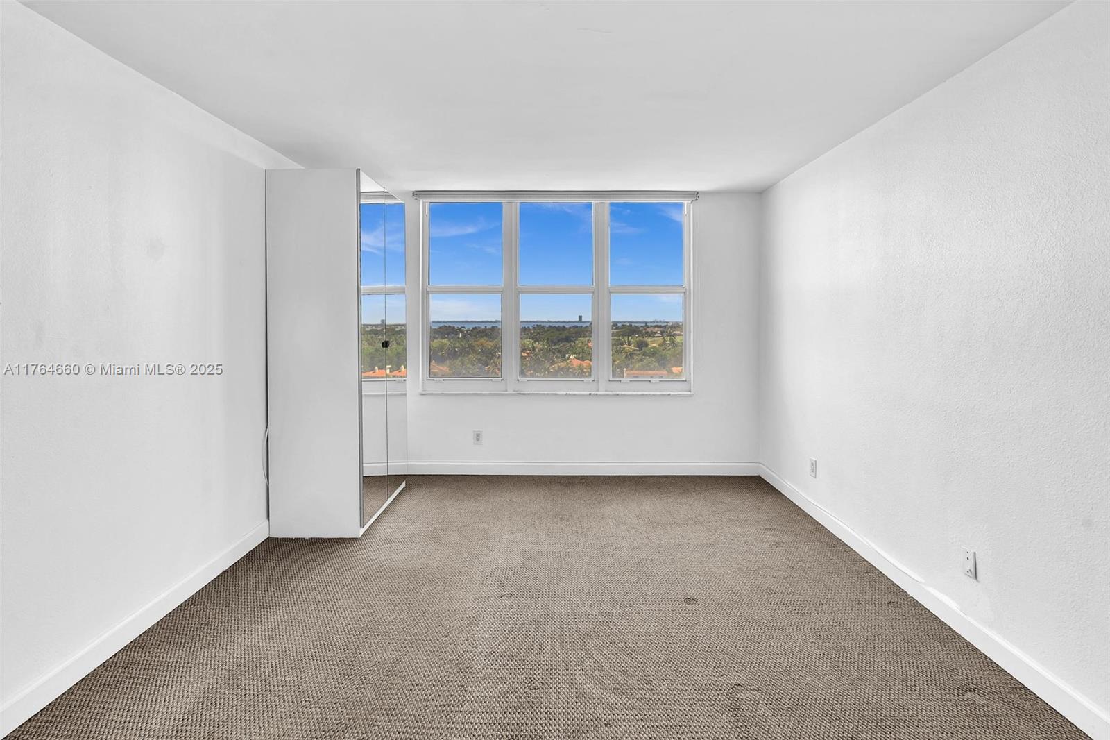 5600 Collins Avenue, Unit 10J Miami Beach, FL 33140 - Photo 5 of 20 an empty room with a window