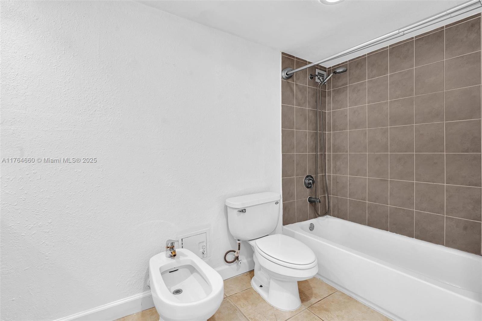 5600 Collins Avenue, Unit 10J Miami Beach, FL 33140 - Photo 7 of 20 a bathroom with a toilet a sink and bathtub
