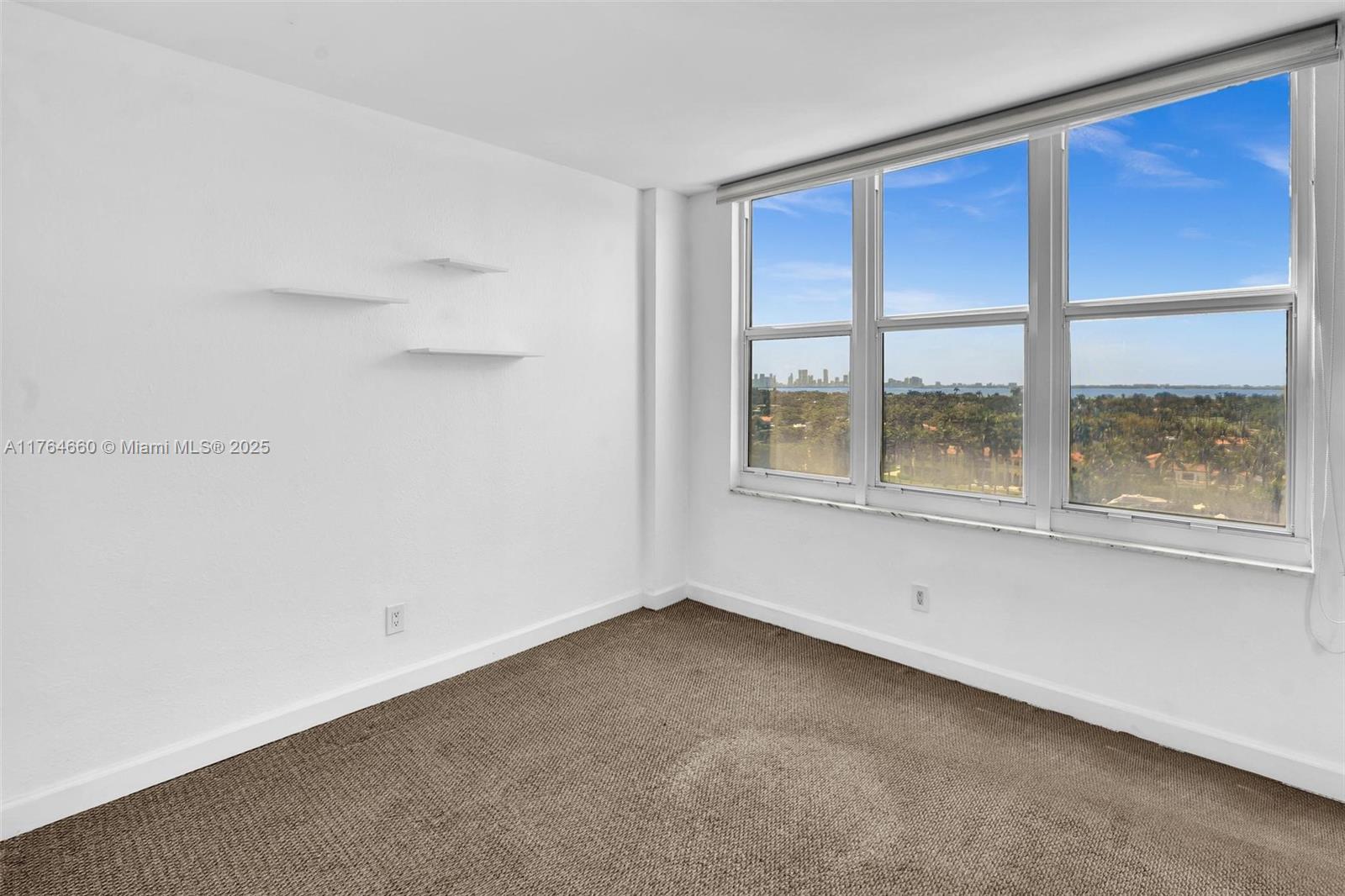 5600 Collins Avenue, Unit 10J Miami Beach, FL 33140 - Photo 8 of 20 an empty room with a window