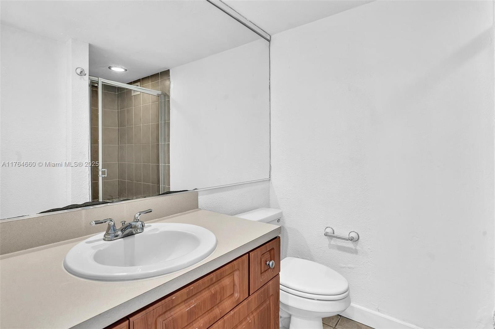5600 Collins Avenue, Unit 10J Miami Beach, FL 33140 - Photo 9 of 20 a bathroom with a sink toilet and a mirror