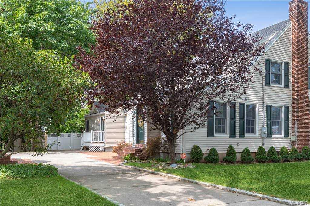 7 Bromleigh Road Garden City, NY 11530 - Photo 1 of 1 a front view of a house with a yard and trees
