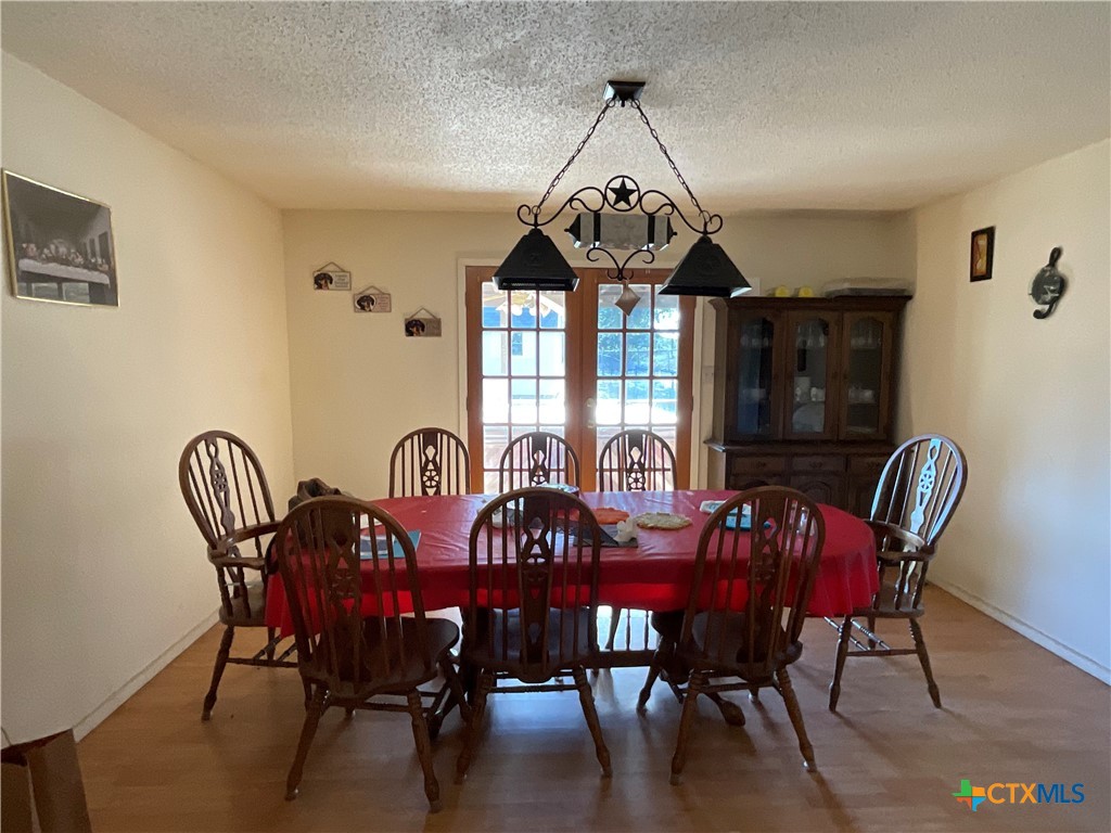 389 Hausmann Road Cuero, TX 77954 - Photo 12 of 48 a view of a dining room with furniture window and wooden floor