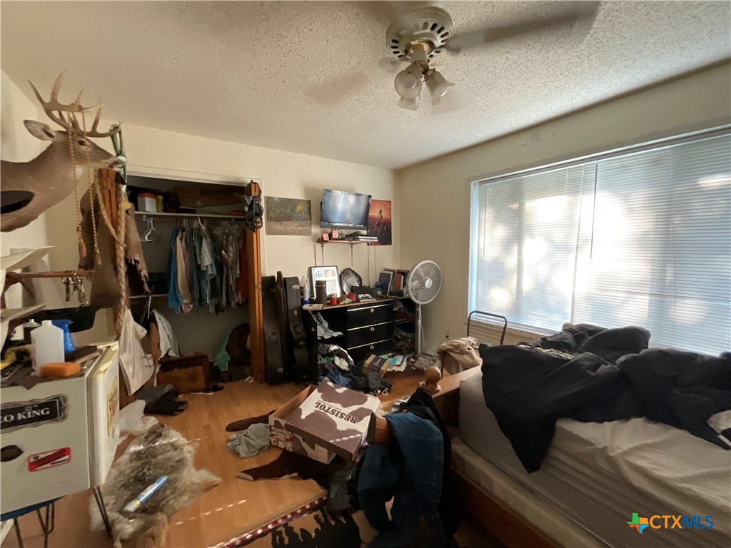 389 Hausmann Road Cuero, TX 77954 - Photo 16 of 48 a living room with furniture a flat screen tv and a window