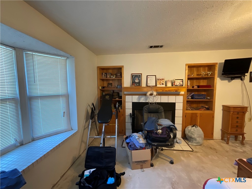 389 Hausmann Road Cuero, TX 77954 - Photo 20 of 48 a living room with furniture and a fireplace