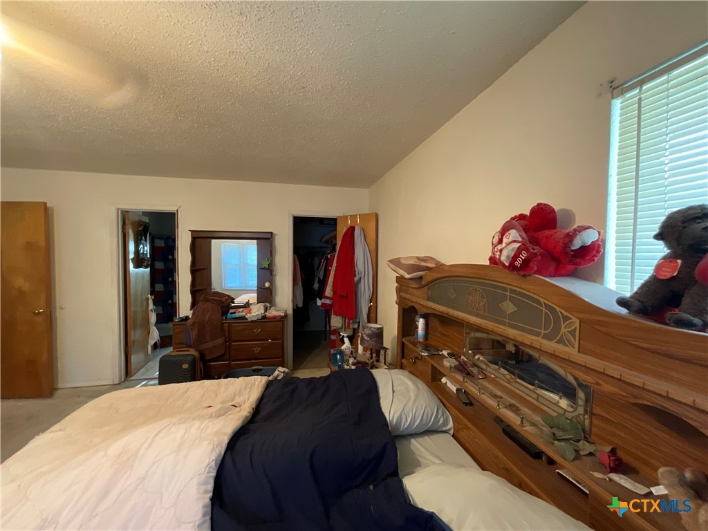 389 Hausmann Road Cuero, TX 77954 - Photo 21 of 48 a bedroom with a bed and dresser