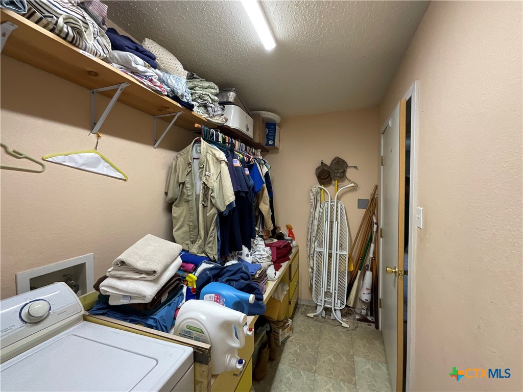 389 Hausmann Road Cuero, TX 77954 - Photo 26 of 48 a view of walk in closet with clothes and shoes