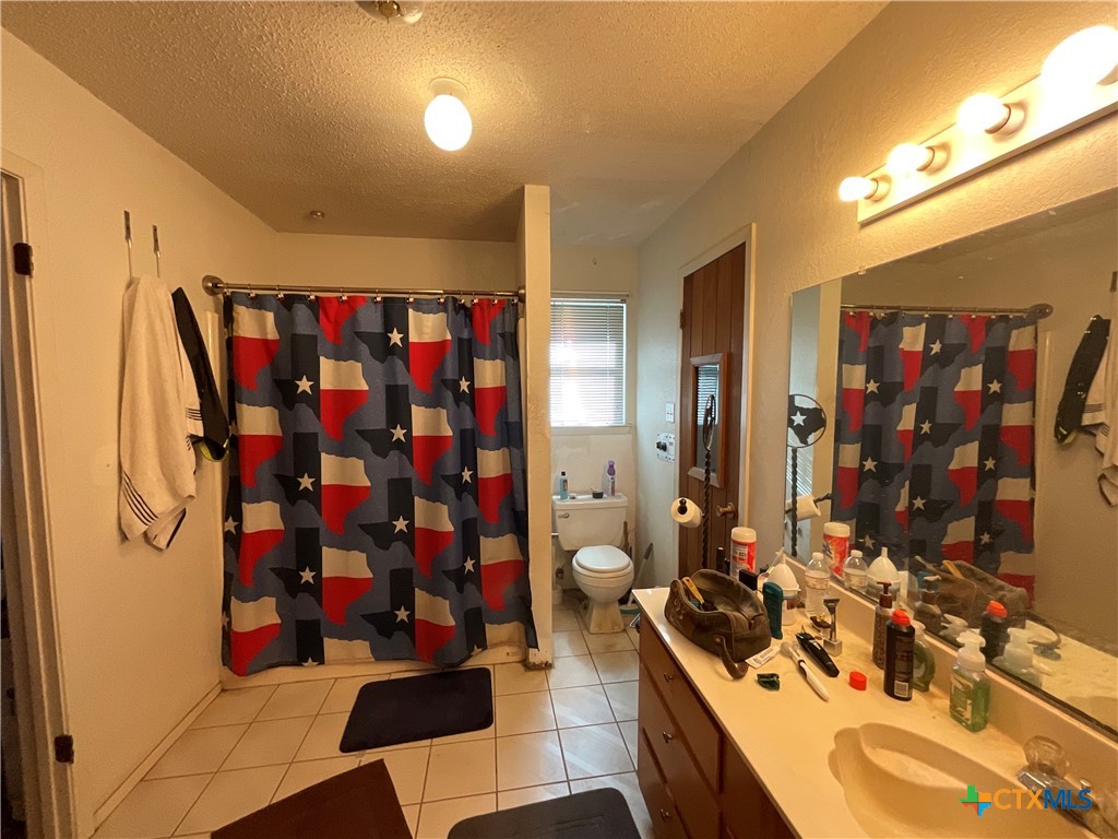 389 Hausmann Road Cuero, TX 77954 - Photo 27 of 48 a view of walk in closet with clothes and shoes