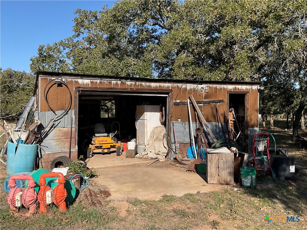 389 Hausmann Road Cuero, TX 77954 - Photo 35 of 48 a view of a garage with a bike and white house