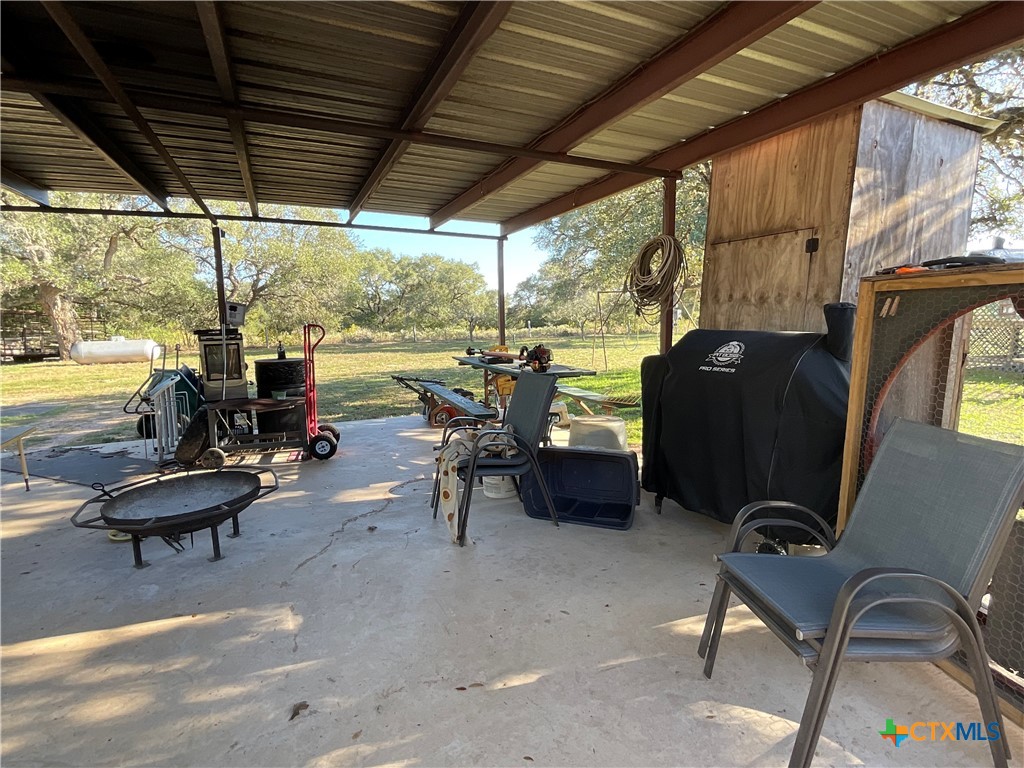 389 Hausmann Road Cuero, TX 77954 - Photo 39 of 48 a view of a patio with chairs and a floor to ceiling window