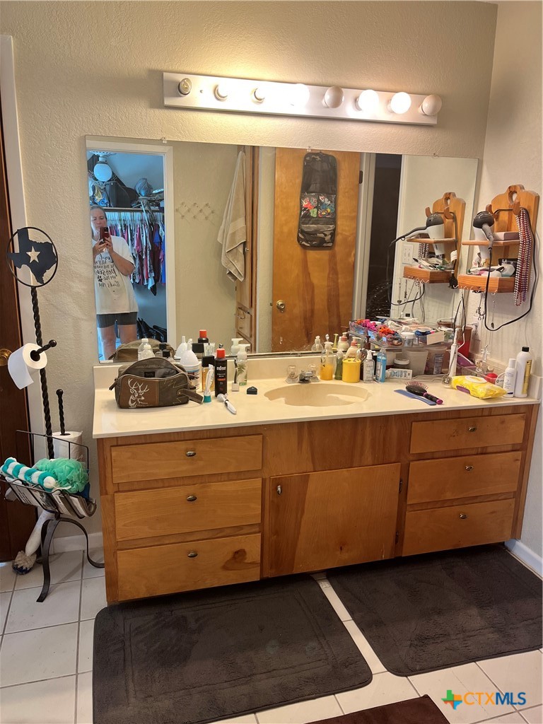 389 Hausmann Road Cuero, TX 77954 - Photo 40 of 48 a bathroom with a sink mirror and vanity