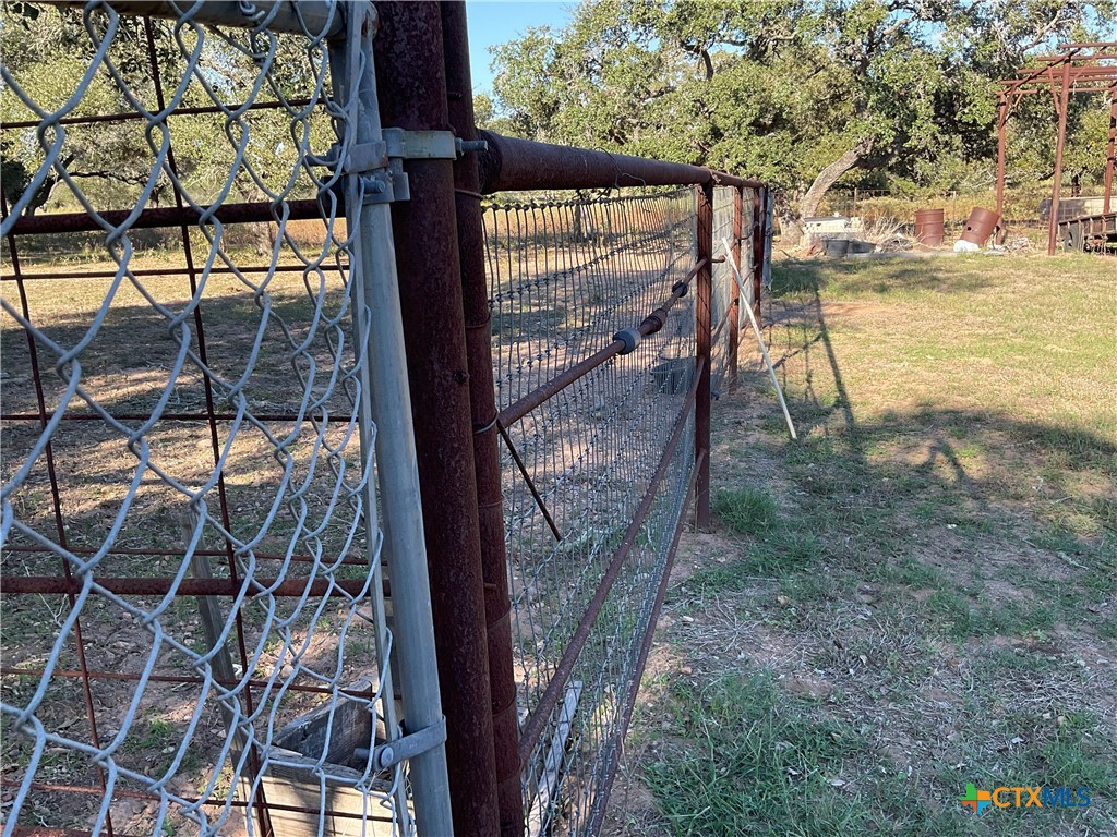 389 Hausmann Road Cuero, TX 77954 - Photo 42 of 48 a view of a balcony with floor to ceiling windows and wooden fence