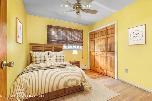 a bedroom with a bed and a large window