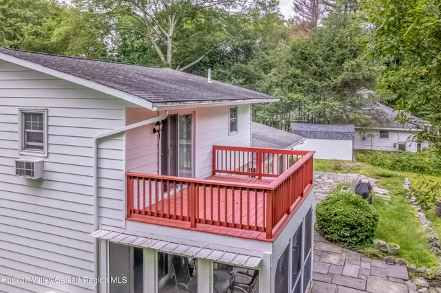 a view of a wooden deck and a backyard