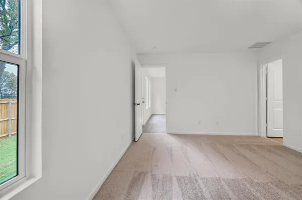 a view of a room with wooden floor and windows
