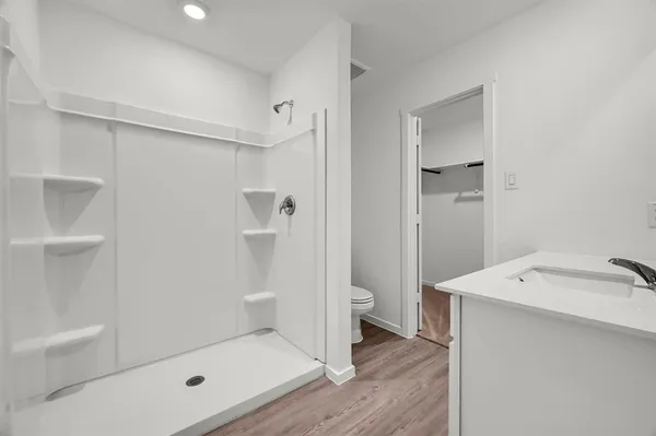 a bathroom with a shower sink and toilet