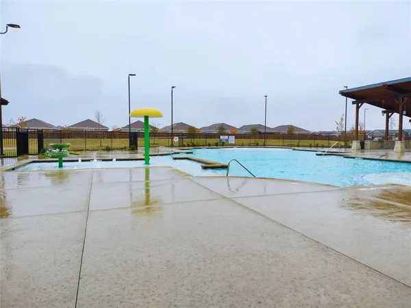 a view of a house with swimming pool and a yard
