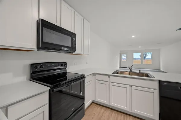 a kitchen with a sink and cabinets