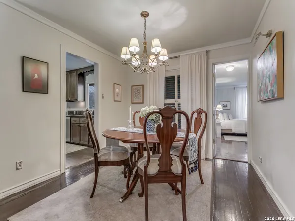 a view of a dining room with furniture and chandelier