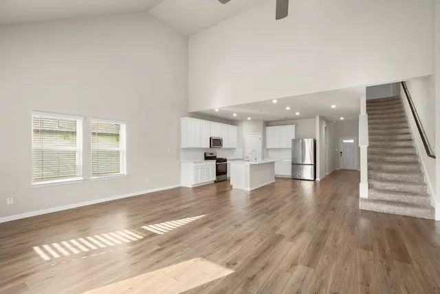 a view of an empty room and wooden floor