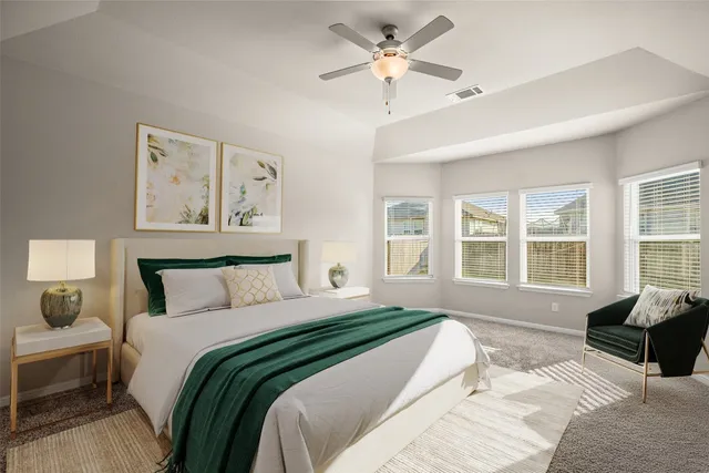 a view of empty room with wooden floor and kitchen view