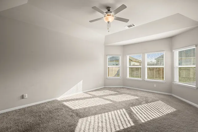 a bedroom with a bed couches and window